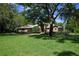 Stately brick home on a large lot, shaded by mature trees, with a well-kept green lawn at 725 Bear Creek Cir, Winter Springs, FL 32708