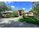 Beautiful brick home featuring manicured landscaping, and an impressive arched window above the front door at 725 Bear Creek Cir, Winter Springs, FL 32708