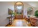 Bright foyer with hardwood floors, high ceilings, and a large arched window for natural light at 725 Bear Creek Cir, Winter Springs, FL 32708