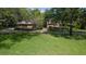 Charming brick home featuring a lush green lawn, mature trees, and manicured landscaping at 725 Bear Creek Cir, Winter Springs, FL 32708