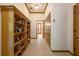 Well-lit hallway featuring hardwood floors, built-in bookshelves, and access to multiple rooms at 725 Bear Creek Cir, Winter Springs, FL 32708