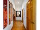 Hallway with hardwood floors and colorful art leading to other rooms in the home at 725 Bear Creek Cir, Winter Springs, FL 32708
