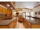 A gourmet kitchen featuring granite countertops, custom cabinetry, and stainless steel appliances at 725 Bear Creek Cir, Winter Springs, FL 32708