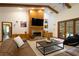 Bright living room with a brick fireplace, high ceilings, and a view of the backyard at 725 Bear Creek Cir, Winter Springs, FL 32708