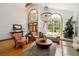Open living room with high ceilings, a chandelier, and large windows, creating a bright and spacious atmosphere at 725 Bear Creek Cir, Winter Springs, FL 32708
