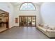 Bright living room with high ceilings, tiled floors and a large arched window at 725 Bear Creek Cir, Winter Springs, FL 32708