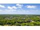 Aerial view of a neighborhood with homes surrounded by trees, highlighting the community's lush setting at 725 Bear Creek Cir, Winter Springs, FL 32708