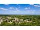 Wide aerial shot showcasing a residential area with homes surrounded by dense, mature trees and greenery at 725 Bear Creek Cir, Winter Springs, FL 32708