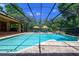 Sparkling pool surrounded by a screen enclosure and lush landscaping at 725 Bear Creek Cir, Winter Springs, FL 32708