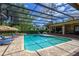 Screened-in pool area with lounge chairs and manicured landscaping at 725 Bear Creek Cir, Winter Springs, FL 32708