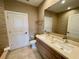Bathroom featuring double vanity, and walk-in shower with decorative tile surround at 7458 Brooklyn Dr, Kissimmee, FL 34747
