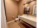 Stylish powder room with a modern floating vanity and decorative mirror at 7458 Brooklyn Dr, Kissimmee, FL 34747