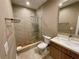 Bathroom boasts neutral color scheme and walk-in shower with decorative tile work at 7458 Brooklyn Dr, Kissimmee, FL 34747