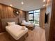Bedroom with two twin beds, wood accent wall, and a large window at 7458 Brooklyn Dr, Kissimmee, FL 34747