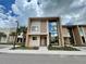 Modern two-story home with a light-colored facade and large window reflecting the sky at 7458 Brooklyn Dr, Kissimmee, FL 34747