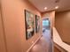 Hallway with carpet, wall art and view into bedroom at 7458 Brooklyn Dr, Kissimmee, FL 34747