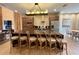 A spacious kitchen featuring a large island with seating, pendant lighting and stainless steel appliances at 7458 Brooklyn Dr, Kissimmee, FL 34747