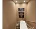 Stairwell with modern art, carpeted stairs, and recessed lighting at 7458 Brooklyn Dr, Kissimmee, FL 34747