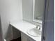 Bright bathroom featuring a sleek white countertop, sink, and a large mirror at 7540 Govern Blvd, Orlando, FL 32822