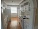 Galley kitchen with white cabinets, updated appliances, and ample counter space at 7540 Govern Blvd, Orlando, FL 32822