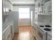Bright kitchen featuring white cabinets, stainless steel appliances, and modern fixtures at 7540 Govern Blvd, Orlando, FL 32822