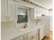 Kitchen with white cabinets, tile backsplash, and stainless steel faucet at 7540 Govern Blvd, Orlando, FL 32822