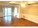 Spacious room showcasing hardwood floors, recessed lighting, with sliding door access to the patio at 7540 Govern Blvd, Orlando, FL 32822