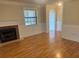 Bright living room featuring hardwood floors, traditional fireplace, and classic architectural details at 7540 Govern Blvd, Orlando, FL 32822