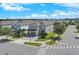 Street view of a two-story home featuring manicured landscaping and paved drive at 7584 Marker Ave, Kissimmee, FL 34747