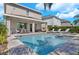 Backyard pool with lounge chairs, dining area and a covered patio for shade and relaxation at 7584 Marker Ave, Kissimmee, FL 34747