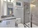 Bathroom features a glass shower, granite countertop, and a bright vanity at 7584 Marker Ave, Kissimmee, FL 34747