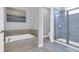 Stylish bathroom boasts a soaking tub, glass shower, and modern finishes at 7584 Marker Ave, Kissimmee, FL 34747