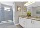 Modern bathroom features a glass shower, granite countertop, and dual sinks at 7584 Marker Ave, Kissimmee, FL 34747