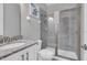 Cozy bathroom features a glass shower, granite countertop, and vanity at 7584 Marker Ave, Kissimmee, FL 34747
