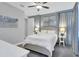 Serene bedroom featuring a queen bed, stylish decor, and soft, natural lighting at 7584 Marker Ave, Kissimmee, FL 34747