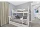Neutral bedroom featuring a bunk bed, a small dresser, and simple decor at 7584 Marker Ave, Kissimmee, FL 34747