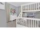 Cozy bedroom featuring white bunk beds, dresser, and TV for entertainment at 7584 Marker Ave, Kissimmee, FL 34747