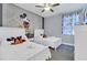 Charming bedroom with two beds, Mickey Mouse themed wall art, and ceiling fan at 7584 Marker Ave, Kissimmee, FL 34747