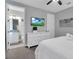 Inviting bedroom with en-suite bathroom, TV, and dresser for added convenience at 7584 Marker Ave, Kissimmee, FL 34747