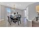Elegant dining room featuring a chandelier, windows and a beautifully set table for six at 7584 Marker Ave, Kissimmee, FL 34747
