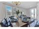 Dining room with modern chandelier and place settings on a long, polished table at 7584 Marker Ave, Kissimmee, FL 34747