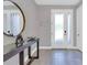 Inviting foyer with tiled floors, contemporary console table, and decorative mirror at 7584 Marker Ave, Kissimmee, FL 34747