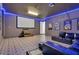 Entertainment awaits in this home theater with a large screen, blue LED lighting, and comfortable seating at 7584 Marker Ave, Kissimmee, FL 34747