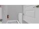 Bright laundry room with gray walls, neutral tile, and stacked washer and dryer at 7584 Marker Ave, Kissimmee, FL 34747