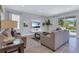 Stylish living room with neutral furnishings, a modern entertainment center, and sliding glass doors to the pool at 7584 Marker Ave, Kissimmee, FL 34747