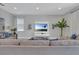 Bright living room featuring a media center, large sofa and neutral color palette at 7584 Marker Ave, Kissimmee, FL 34747