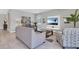 Bright living room featuring tile floors, a modern sofa and neutral color palette at 7584 Marker Ave, Kissimmee, FL 34747