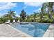 Backyard pool and spa area with privacy landscaping, lounge chairs and tropical foliage at 7584 Marker Ave, Kissimmee, FL 34747