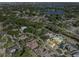 Expansive aerial view displays the property nestled among mature trees in a tranquil, residential neighborhood at 7957 S Park Pl, Orlando, FL 32819