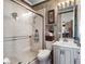 Bathroom featuring tile shower, sink, vanity and decorative wall hangings at 7957 S Park Pl, Orlando, FL 32819